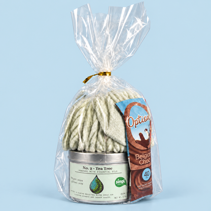 Tea Tree candle gift set with sage green socks and Options hot chocolate